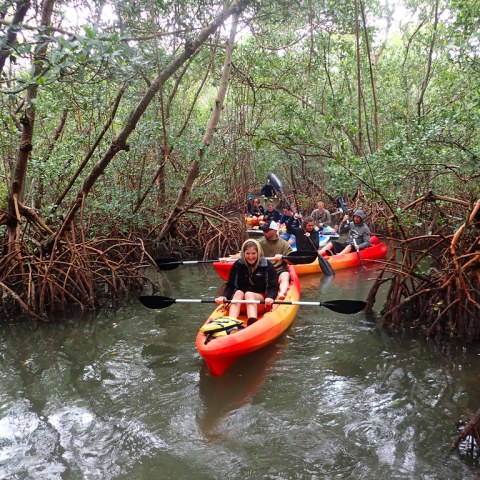 a man riding on the back of a boat in the water