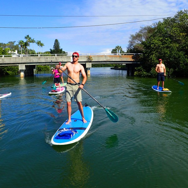 a group of people riding on the back of a boat in the water