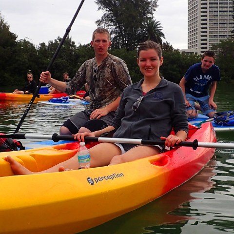 a group of people riding on the back of a boat