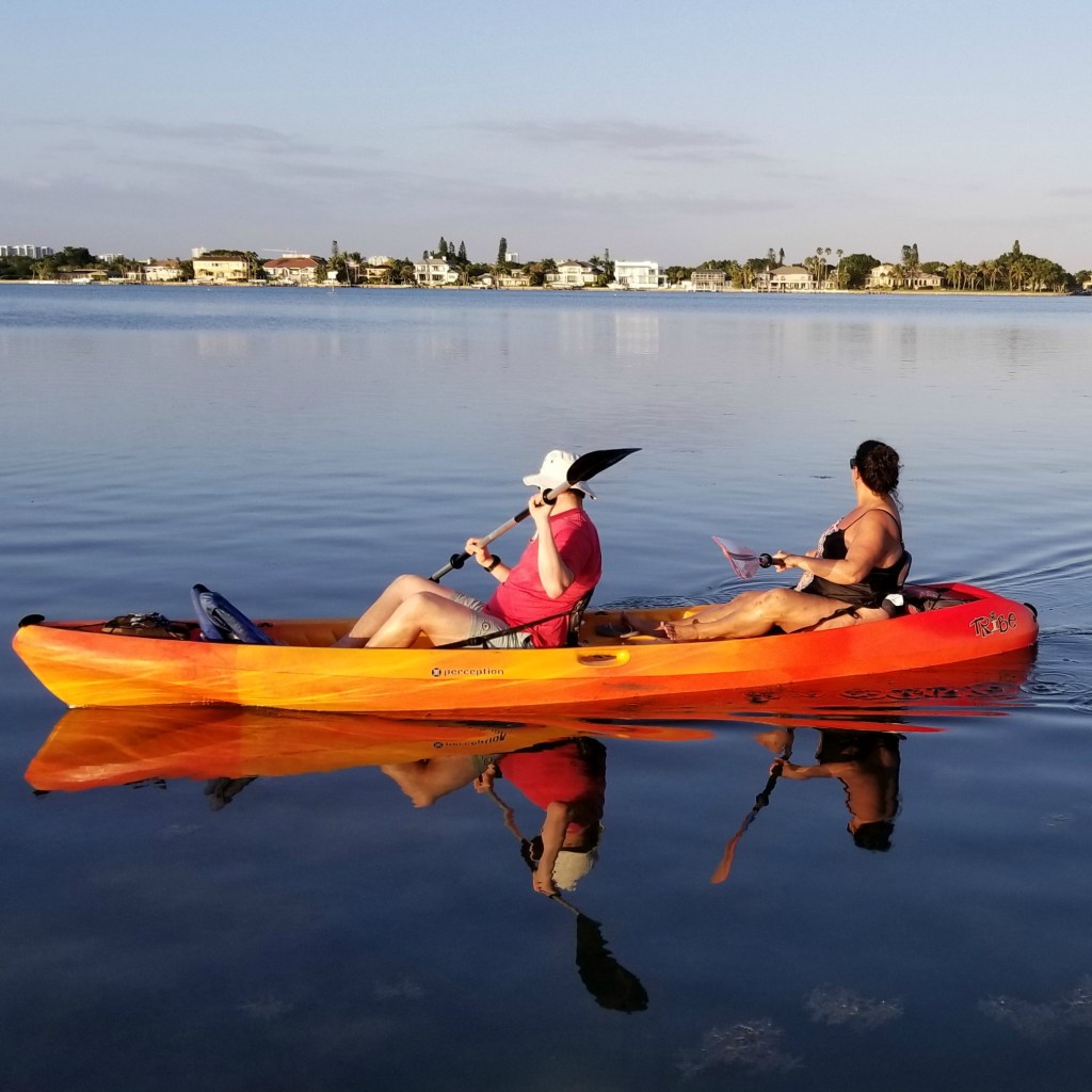 a group of people in a boat on a body of water