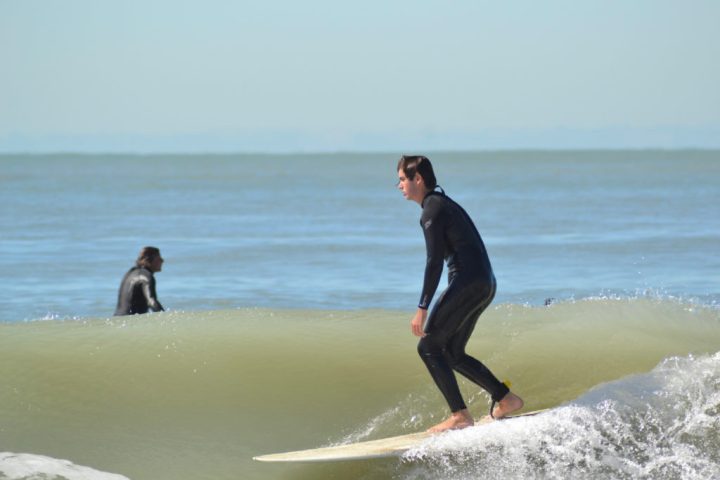 a person riding a wave on a surfboard in the water