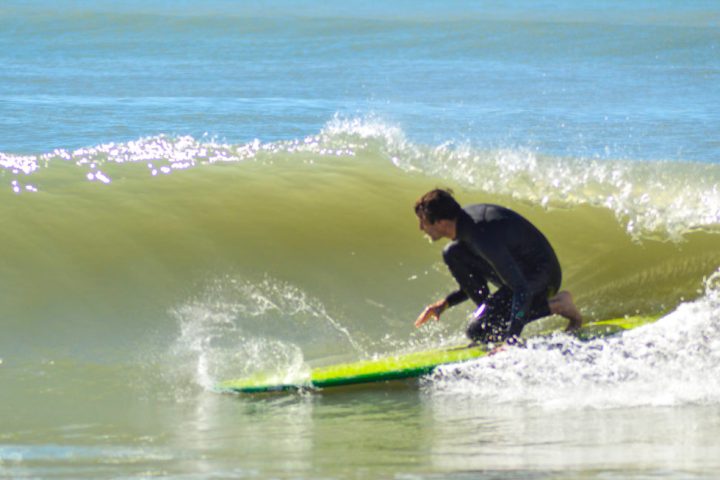 a man riding a wave on a surfboard in the ocean