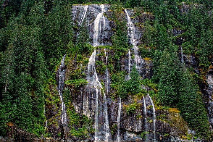 a large waterfall over a body of water